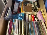 a cardboard box full of cds and cds on the floor