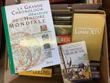 many books that are in a box on the floor