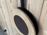a wooden wall with a black speaker on it