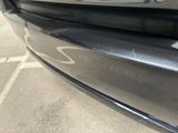 a close up of a car ' s bumper with a sticker on it