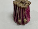 a small purple vase with a rope wrapped around it