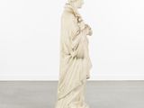 a white statue of a man holding a child in his arms