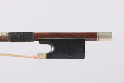 a close up of a violin bow with a wooden handle