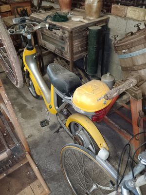 a yellow bike parked in a garage with a basket on the back