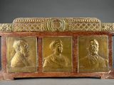 an image of a gold plated casket with three men