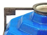 a blue vase sitting on top of a metal stand
