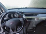 a dashboard of a car with a steering wheel and dashboard controls