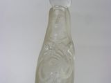 a clear glass bottle with a face on it