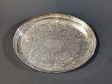 a silver tray on a table with a black background