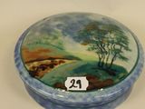 a small blue and white box with a painting on it