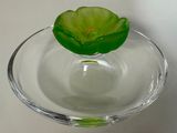 un bol en verre contenant une fleur, posé sur une table