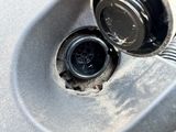 a close up of a car ' s wheel with a drain in it