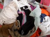 a suitcase full of clothes and a teddy bear in it