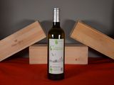 a bottle of wine sitting on a table next to two wooden boxes