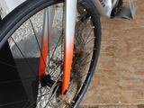 a close up of a bike parked on a sidewalk