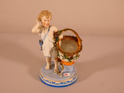 a figurine of a boy holding a basket of flowers