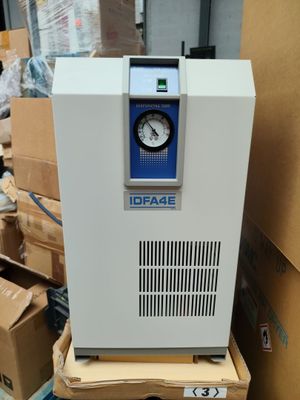 an image of a white machine sitting on top of a pile of boxes