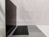 an open laptop computer sitting on top of a white table