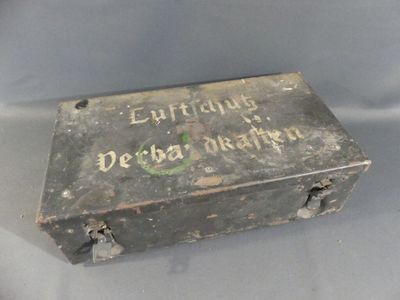 an old metal box with writing on it sitting on a table