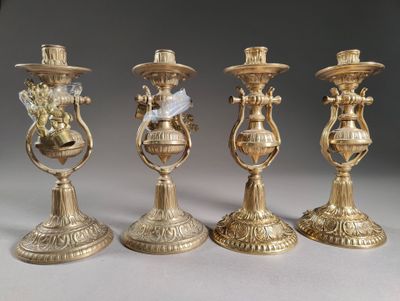 three gold candlesticks with a bird on top of them on a table