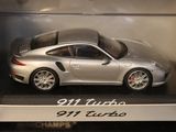 a toy porsche 911 turbo car in a display case