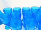a lot of blue glasses sitting on a table