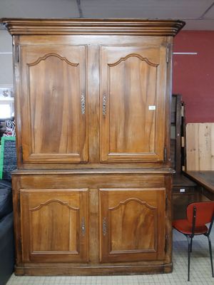 a large wooden cabinet in the middle of a room