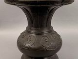 a black vase that is sitting on a table