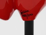 a close up of a red sculpture of a person ' s head
