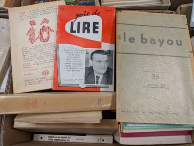 many books stacked on top of each other in a box