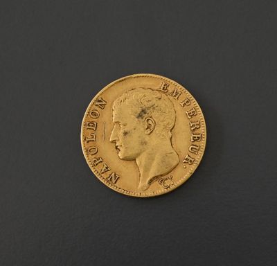 a close up of a gold coin on a black surface