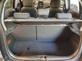 the back of a car with the trunk open and the seats folded down