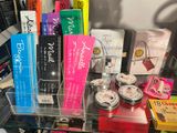 a glass display case filled with various cosmetics and beauty products