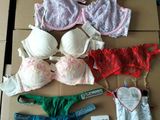 several bras and panties are on a cardboard box with a price tag