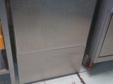 a silver dishwasher sitting in the middle of a kitchen