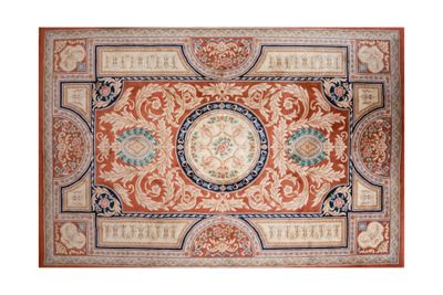 a red and blue rug with a medallion design on it