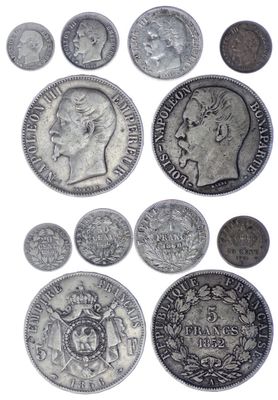 a close up of a bunch of coins on a white surface