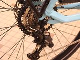 a blue bicycle with a chain attached to the front wheel