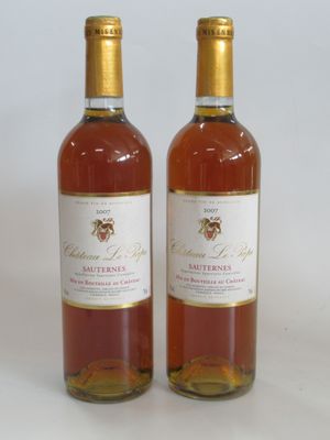two bottles of wine sitting next to each other on a white surface