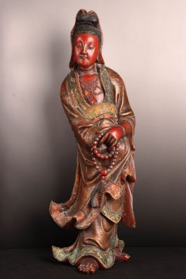 statue of a woman holding a bunch of grapes in her hands