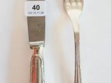 two forks and a knife on a white table