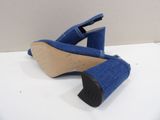 the heel of a pair of blue denim shoes on a white surface