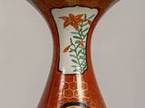 a vase that has a picture of a bird on it
