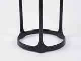 a close up of a black side table with a glass top