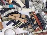 many different types of watches on a white surface