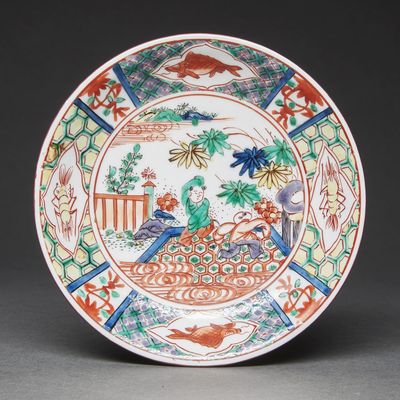 a colorful plate with a bird on it on a table