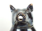 a black bear figurine sitting on a white surface