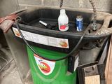 un seau vert avec une bouteille de produit nettoyant à côté