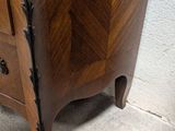 a wooden cabinet with a mirror on top of it