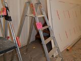 a ladder leaning against a wall in a room that is being remodeled